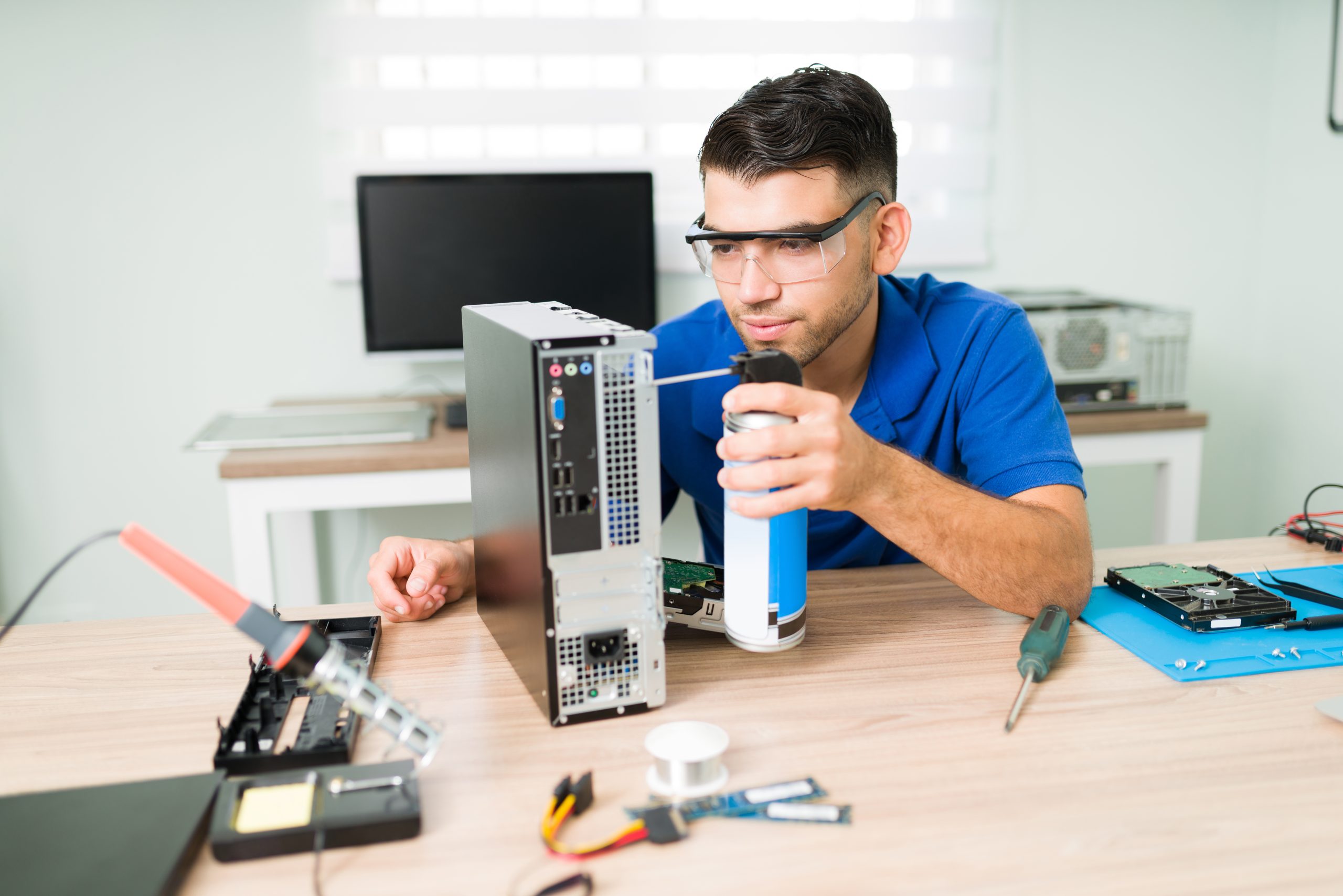 Professional technician using compressed air